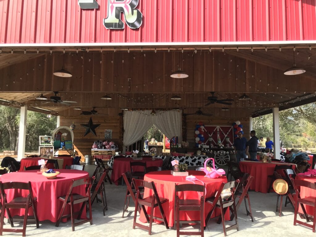 round red tables set up in open air barn for outdoor party